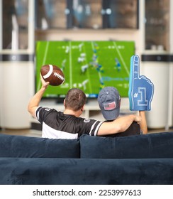 Fans of american football. Father and son watching TV. - Shutterstock ID 2253997613