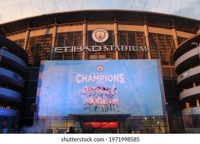 Fans celebrate Manchester City becoming English Premier League Champions at the Etihad Stadium, where a big screen has been erected, on the 11th May 2021