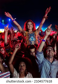 Fans cheering at music festival - Shutterstock ID 2104577618