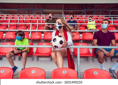 Fans With Masks During Covid-19 In Soccer Stadium Keeping Distance With Lots Of Empty Seats