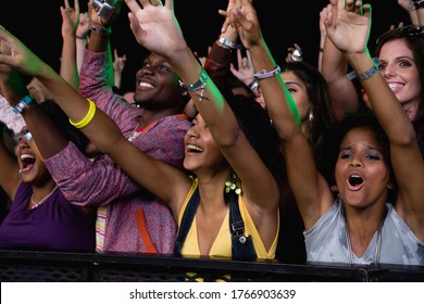 Fans screaming and cheering behind fence - Shutterstock ID 1766903639