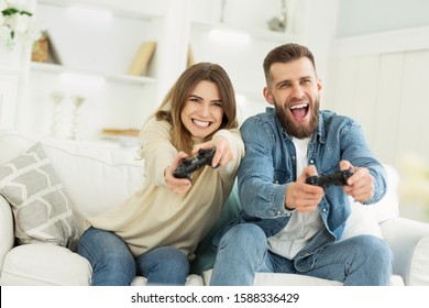 Fans Of Video Games. Overjoyed Couple Playing On Game Console, Resting On Weekends At Home