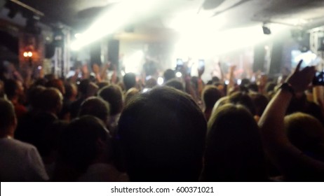 Fans Waving Their Hands And Hold The Phone With Digital Displays The Crowd At Concert.