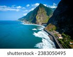 Fantastic aerial view of the coast at São Vicente, Madeira, Portugal, where the mighty waves crash on the black beach, surrounded on high mountains