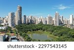 Fantastic aerial view of Vaca Brava Park with tropical nature, a lake and modern residential buildings in the horizon. May 3rd, 2023. Goiania, Goias, Brazil 
