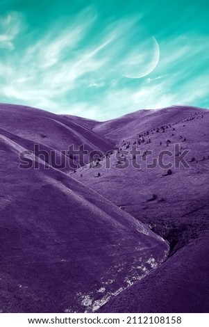 Fantastic alien landscape. Lilac flowers against the background of a green sky with clouds and the moon.