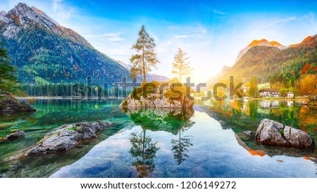 Fantastic autumn sunrise of Hintersee lake. Beautiful scene of trees on a rock island. Location: resort Ramsau, National park Berchtesgadener Land, Upper Bavaria, Germany Alps, Europe
