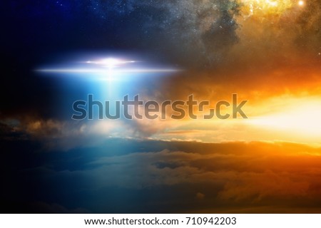 Fantastic background - extraterrestrial aliens spaceship, ufo  in red glowing sky. Elements of this image furnished by NASA