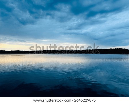 fantastic clouds reflection on the lake surface, sunset twilights time, natural colors, evening lake background