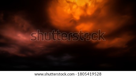 Fantastic concept mystical horror background from another planet from the paranormal world, fantasy style. Dramatic red black orange sky with scary hellish clouds and terrible shadows and fiery light