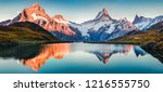 Fantastic evening panorama of Bachalp lake / Bachalpsee, Switzerland. Picturesque autumn sunset in Swiss alps, Grindelwald, Bernese Oberland, Europe. Beauty of nature concept background.