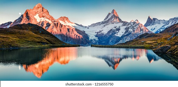 Фантастическая вечерняя панорама озера Бачалп/Бачалпзее, Швейцария. Живописный осенний закат в швейцарских Альпах, Гриндельвальде, Бернском Оберланде, Европе. Красота природы концепции фон.