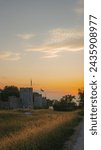 Fantastic images of an unbeatable summer sunset in Visby, Gotland, capture the soft glow over the horizon, the silhouettes of medieval walls, and the boats