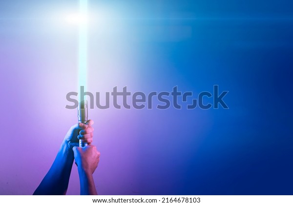a\
fantastic laser sword lightsaber in the hands of a\
man