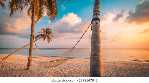 Fantastic leisure wellbeing travel landscape. Closeup hammock on palm trees amazing sunset beach. Sea sand sky summer background. Best vacation destination carefree island inspire positive life health - Powered by Shutterstock