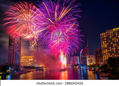 Fantastic Multicolor Firework exploding over the Bangkok Cityscape river side for Celebration, Business architecture and celebration and happy new year and merry Christmas concept