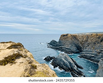 Fantastic rocky coast, cloudy sky, twilights time, ocean horizon - Powered by Shutterstock