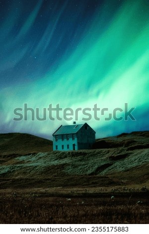 Fantastic scenic of Aurora borealis or northern lights glowing over abandoned scandinavian house on hill in remote location on the night at Iceland