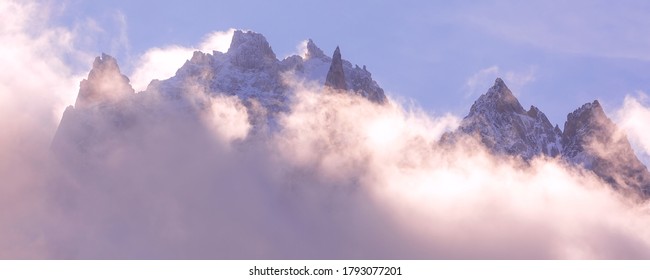 Fantastic Snow Mountains Landscape Banner Background. Colorful Pink And Blue Clouds Overcast Sky. French Alps, Europe