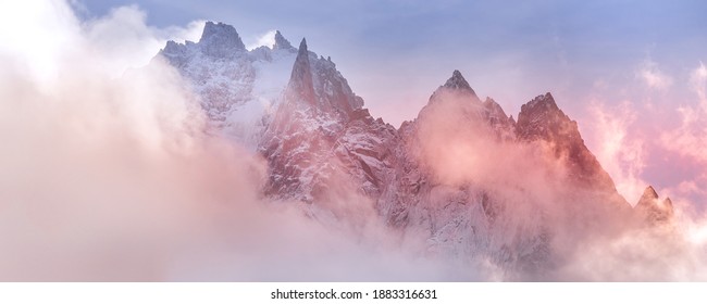 Fantastic snow mountains landscape banner background. Colorful pink and blue clouds overcast sky. French Alps, Chamonix Mont-Blanc, France