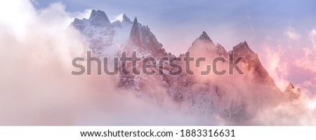 Fantastic snow mountains landscape banner background. Colorful pink and blue clouds overcast sky. French Alps, Chamonix Mont-Blanc, France