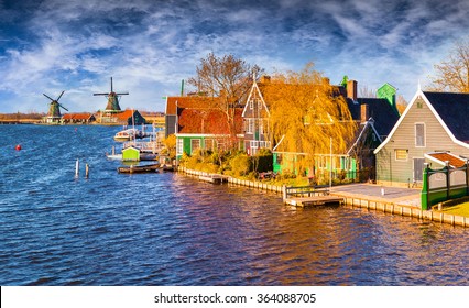 Fantastic spring view of Dutch architecture on the water channel in Zaanstad village. Zaanse Schans Windmills and famous Netherlands canals, Europe. 