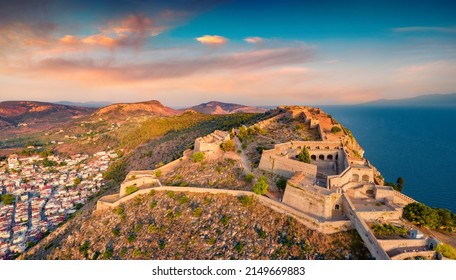 Fantastic summer view from flying drone of fortress of Palamidi. Stunning evening view of Peloponnese peninsula, Greece, Europe. Aerial cityscape of Nafplion town. Traveling concept background.