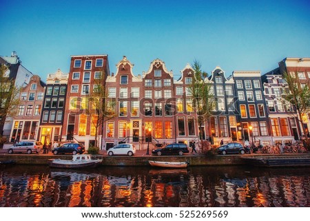 Fantastic sunset that shines on buildings and reflected in the water. Amsterdam is the capital and most populous city in Netherlands. 