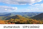 The fantastic view from Brasstown Bald mountain ( the highest mountain in Georgia) colorful in Fall season with white fluffy clouds and blue sky, North Georgia in USA.