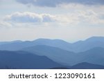 The fantastic view from Brasstown Bald mountain ( the highest mountain in Georgia) on a hazy day, mountains looks silhouette with white fluffy clouds and blue sky, North Georgia in USA.