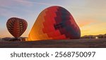 Fantastic view as hot air balloons take flight with the rising of the sun