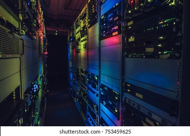 Fantastic view of the mainframe in the data center rows. Shot of a corridor in large working data center full of rack servers and supercomputers. Data centre interface.