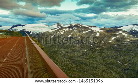 Fantastic view on mountains landscape from Dalsnibba viewpoint, Geiranger Skywalk platform floor surface and glass guard rail, Norway.