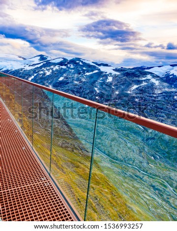 Fantastic view on mountains landscape from Dalsnibba viewpoint, Geiranger Skywalk platform floor surface and glass guard rail, Norway.