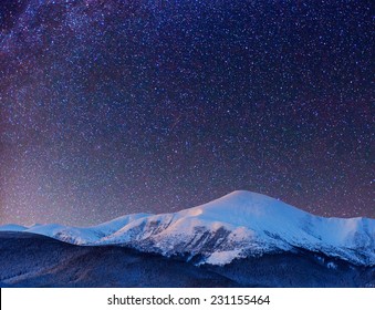 fantastic winter meteor shower and the snow-capped mountains - Powered by Shutterstock