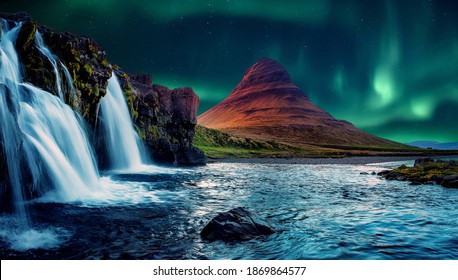 Fantastic Winter Scenery. Kirkjufell Mountain With Beautiful Aurora Borealis And Frozen Water Falls In Winter, Iceland. One Of The Famous Natural Heritage In Iceland. Incredible Nature Landscape