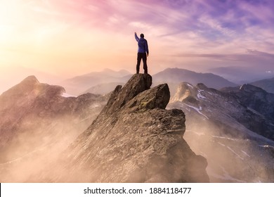Fantasy Adventure Composite with a Man on top of a Mountain Cliff with Dramatic Landscape in Background during Sunset or Sunrise. Landscape from British Columbia, Canada. - Shutterstock ID 1884118477
