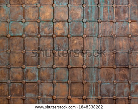 Fantasy background: the surface is sheathed with copper sheets and reinforced with a lattice. Middle Ages, oxidized metal, knight's castle