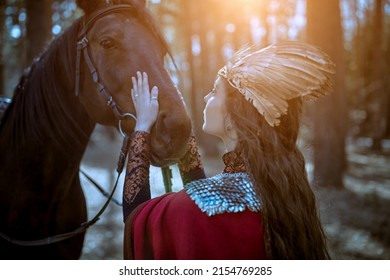 Fantasy. A beautiful valkyrie is talking to her horse while standing in the forest. Scandinavian mythology. 