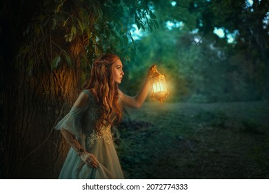 Fantasy elf princess woman walks in dark night forest, holding glowing lantern in hands. Redhead fairy girl. Summer nature forest green tree. Long red hair, pointy elf ears, medieval vintage dress.