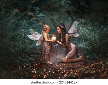fantasy fairy woman mom gives magic light glowing flower to little happy pixie girl. Dark night summer green forest trees. Butterfly costume pink dress. Smiling elf face in fairy tale story world