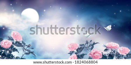 Fantasy fairytale photo background of beautiful fairy rose flower garden and butterflies, magical deep blue dark night sky, shining stars and glowing moon. Idyllic tranquil fabulous panoramic scene.