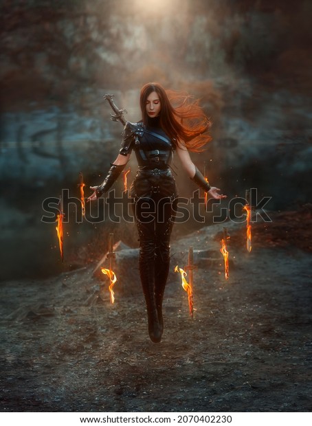 Fantasy fighting woman assassin in levitation soars\
in air with burning daggers. Red-haired girl warrior in black\
leather costume. ninja soldier with knives, fire magic. Hair\
fluttering fly in wind.