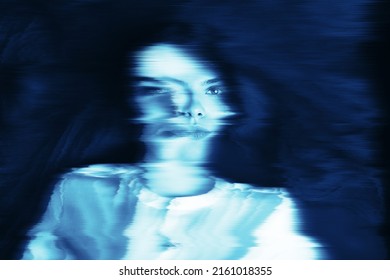 Fantasy, illusion and sci-fi concept. Abstract beautiful woman portrait in blue neon futuristic glitch glowing hologram effect. Bright vivid filter applied. Pixel stretch and motion blur effect