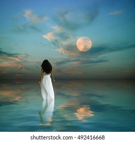 fantasy image of a beautiful women in the middle of the ocean during dawn
