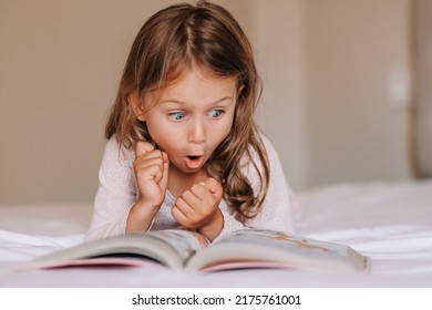 Fantasy Literature. Emotional Child Girl Read Interesting Book In Bed. Small Kid Enjoy Reading. Fantasy And Fantastic. Developing Child Fantasy And Imagination Imaginary World. Fairy Tale Bedtime Read