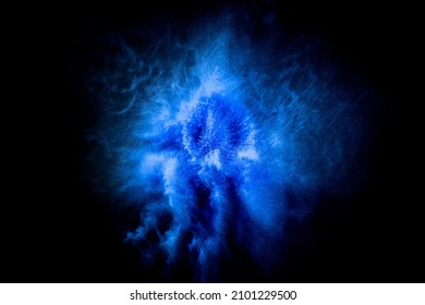 Fantasy, mystic. Stardust. Explosion of blue, navy color, fluid and neoned powder on dark studio background with copy space. Trendy, modern colors. Festival, design, beauty concept. Splashing of