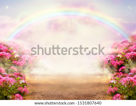 Fantasy panoramic photo background with pink rose garden, misty path leading to fabulous rainbow unicorn house. Idyllic tranquil morning scene and empty copy space. Road goes across hills to fairytale