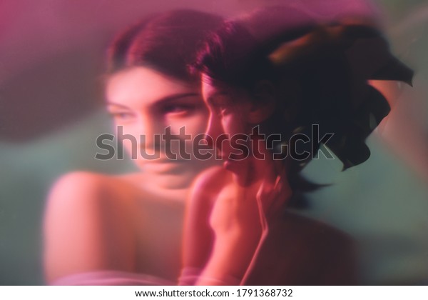 Fantasy portrait.\
Feminine elegance. Sensual woman face blur silhouette in neon red\
light double exposure noise effect. Mindfulness tranquility.\
Dreamlike\
contemplation.