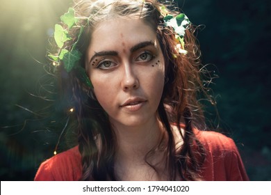 Fantasy. Portrait Of A Young Brunette Woman In The Form Of An Elf, Druid Or Fairy. Dark Background In The Background